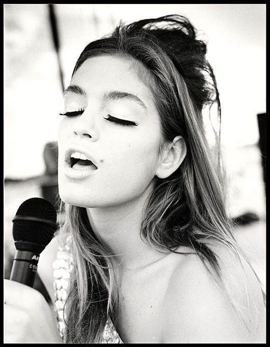 Cindy Crawford Singing Country Western in Cheyenne Wyoming. 1989 Cindy Crawford Singing Country Western in Cheyenne Wyoming. 1989 by Arthur elgort, the model in a pailette top singing into a microphoen, eyes closed