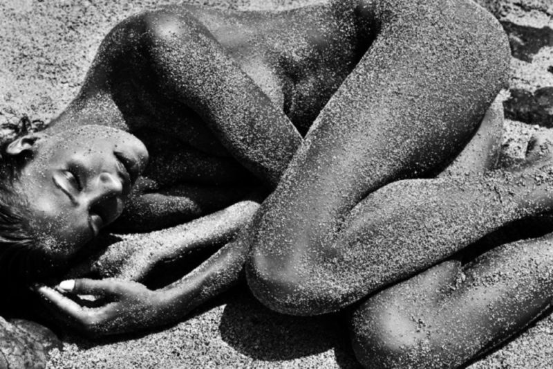 Petra Grand Fond, Shell Beach. 2015 Petra Grand Fond, Shell Beach. 2015, nude model covered in sand lying on the ground crouched together