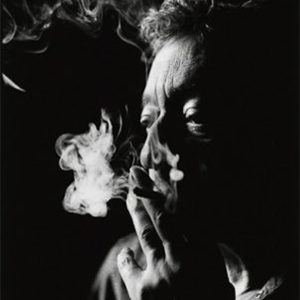 Serge Gainsbourg by Nigel Parry, black and white high contrast portrait of the actor smoking