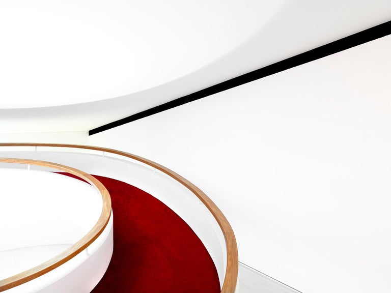 Auditorium Oscar Niemeyer Auditorium Oscar Niemeyer by Massimo Listri, minimalistic white architecture with curved ramp, wooden handrails and red carpet