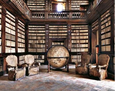 Biblioteca Fermo Biblioteca Fermo by Massimo Listri, library with wooden shelves and gallery and giant globe