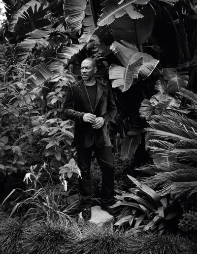 Eddie Murphy, Los Angeles, CA, 2019 Eddie Murphy, Los Angeles, CA, 2019 by Mark Seliger, black and white portrait of the actor in a velvet suit between plants