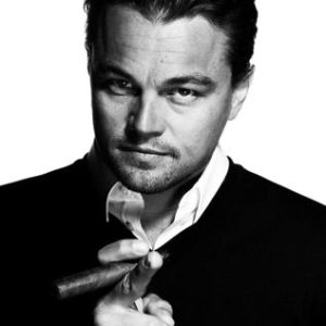 Leonardo DiCaprio Smoke Boss by Nigel Parry, black and white portrait of the actor in a black suit smoking a cigar