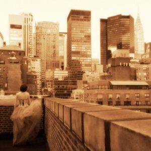 Guido Argentini - Andrea on a Manhattan Roof, model in corset and tulle skirt on a rooftop looking at the skyline