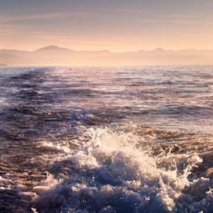 Parting waves by David drebin, ocean waves with mountains in the background
