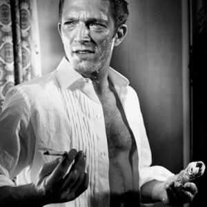 Vincent Cassel by Vincent Peters, black and white portrait of the actor in a white shirt while shaving