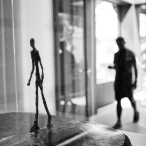 Berggrün Museum by Gérard Uféras, silhouette of a person behind a sculpture