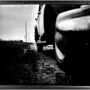Timothy White, Car 37, black-and-white fine art print of car in close-up with landscape in the background