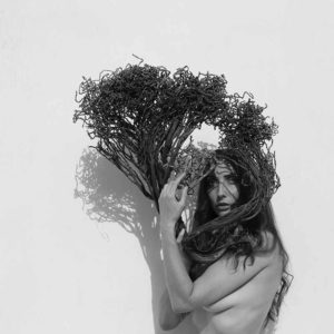 "Emma Two, 2023" by Sylvie Blum. Black-and-white fine art print of nude model holding weed